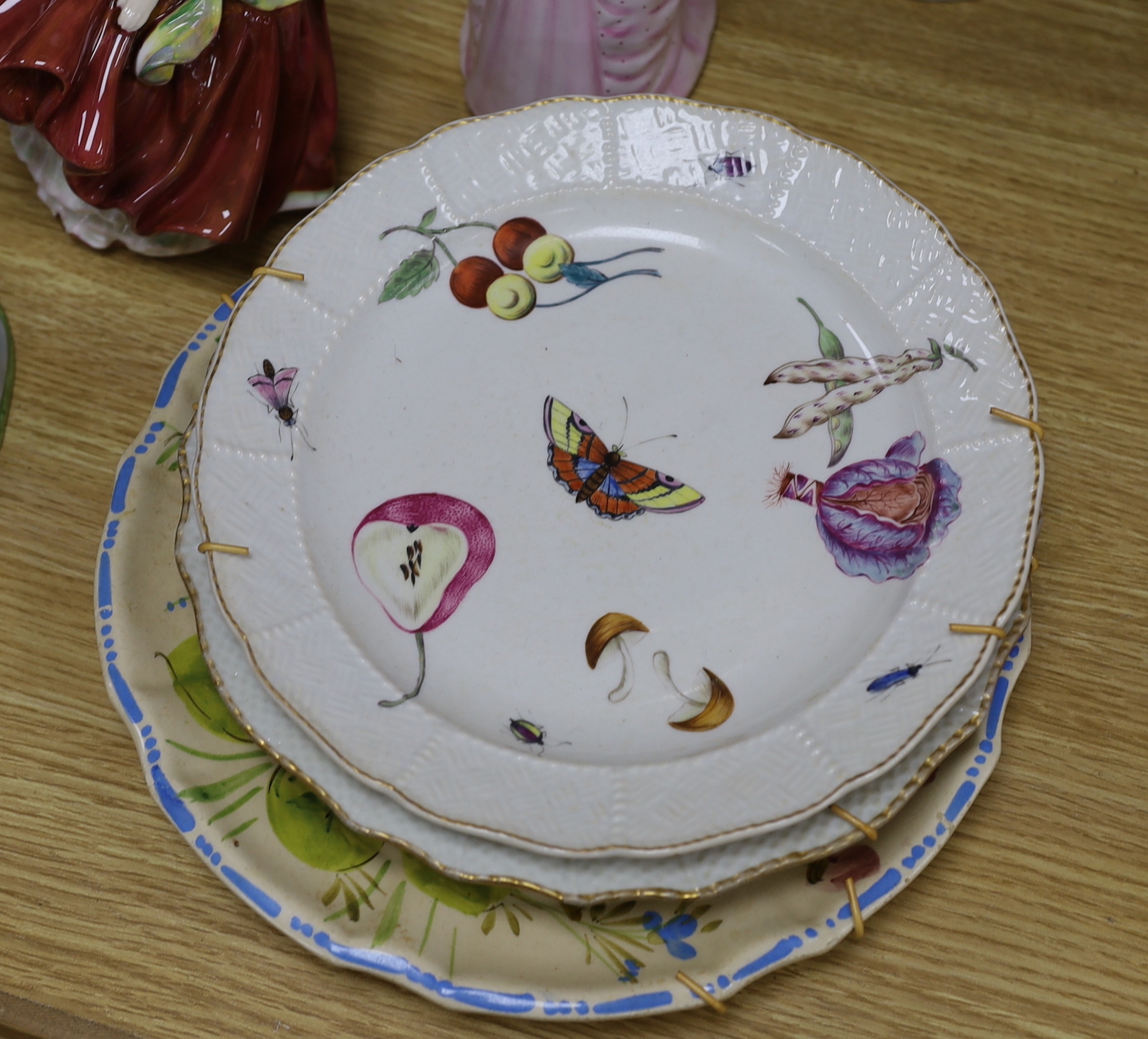 A collection of various porcelain figures including Coalport, Doulton etc. and two dessert plates